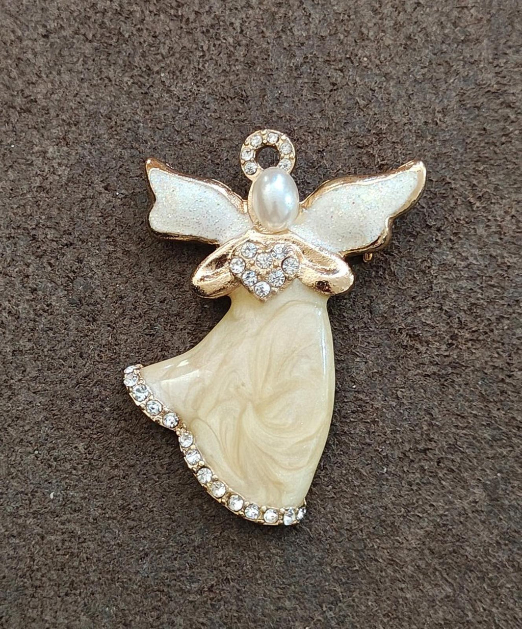 Gold-tone angel brooch with pearlized enamel dress, light blue wings, and sparkling rhinestones