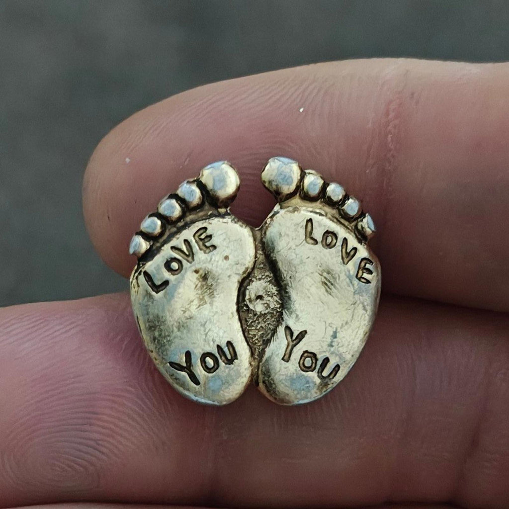 Gold-tone two-footprint brooch pin with "LOVE" and "YOU" text on each shoe