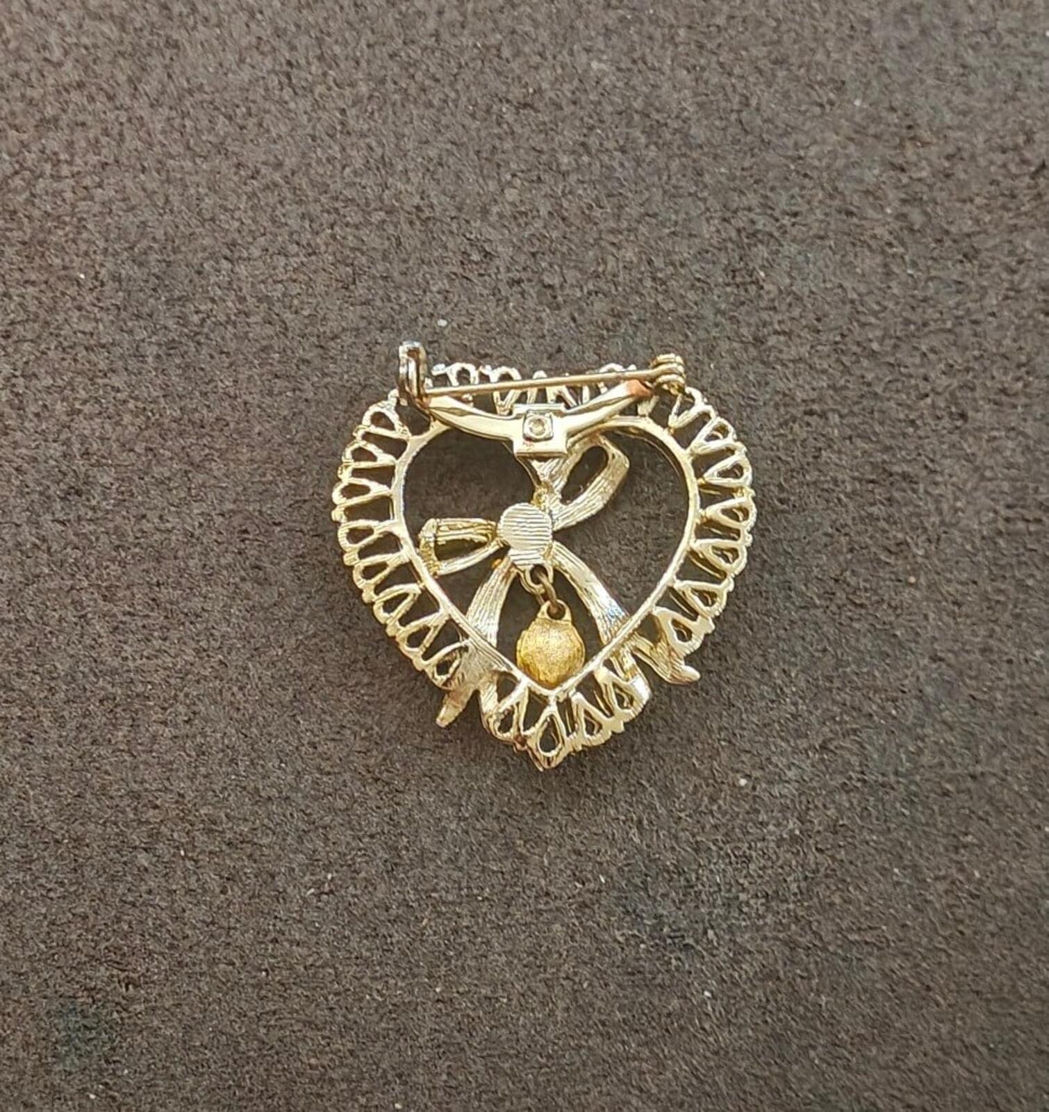 Gold tone heart brooch with openwork design and pin back clasp hardware