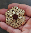 Gold-tone textured wreath brooch with raised cobblestone-like segments