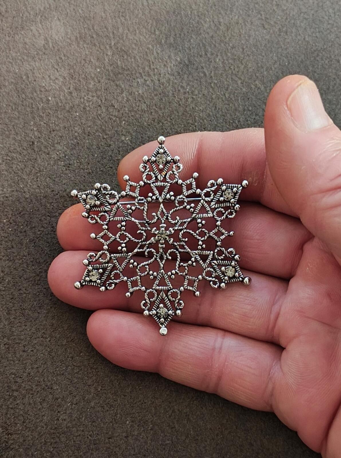 1990s Silver Tone Filigree Snowflake With Clear Rhinestone Accents Brooch.