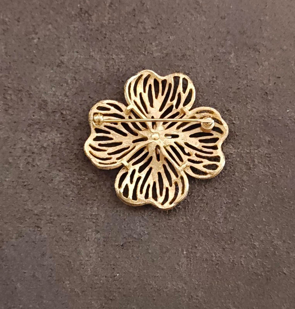 Gold-tone dogwood flower brooch with pin and textured petals, side view