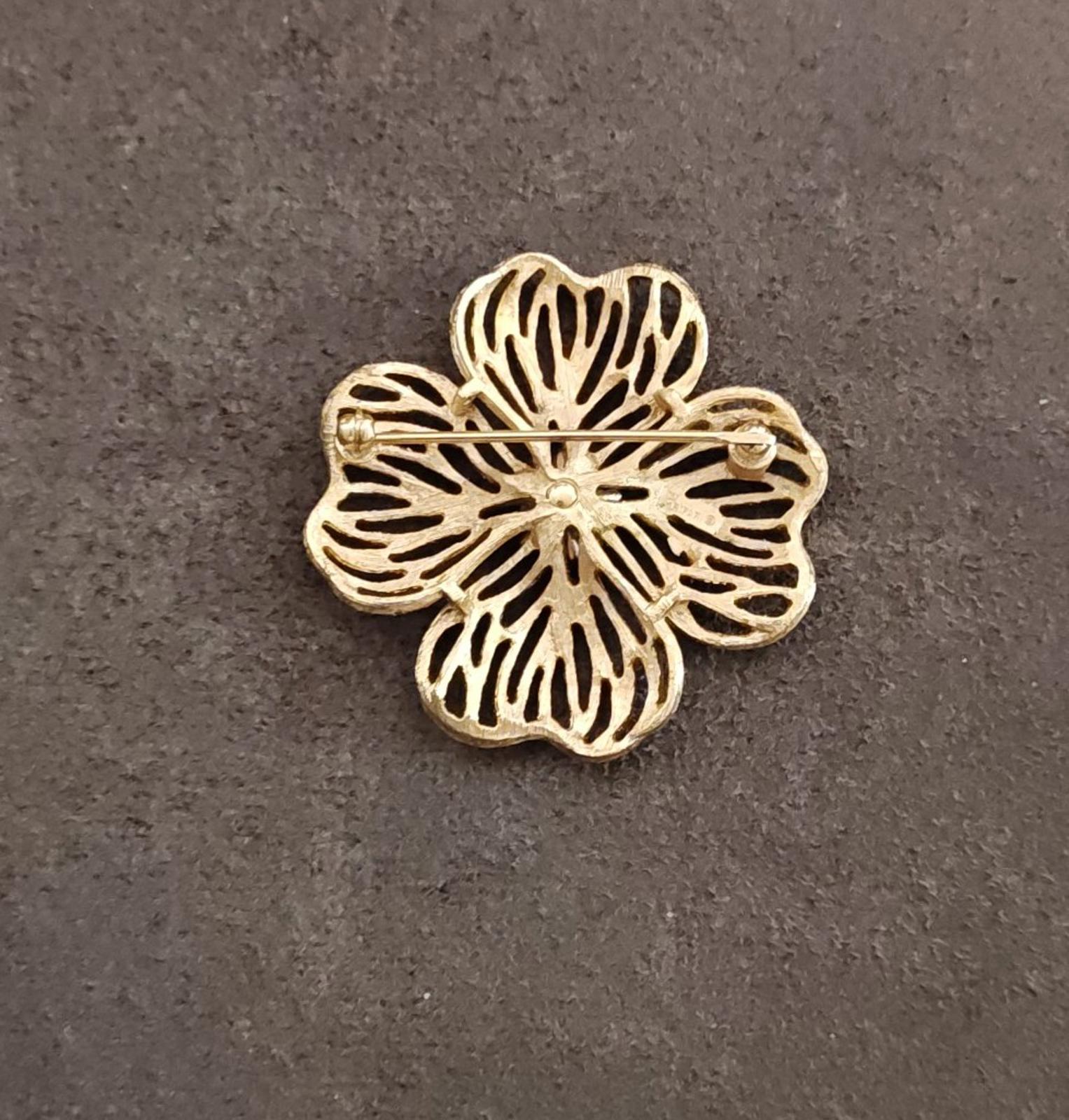 Gold-tone dogwood flower brooch with pin and textured petals, side view