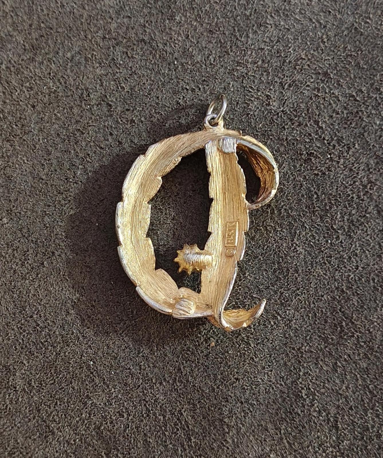 Gold-tone letter D monogram pendant with small white pearl and star-shaped detail