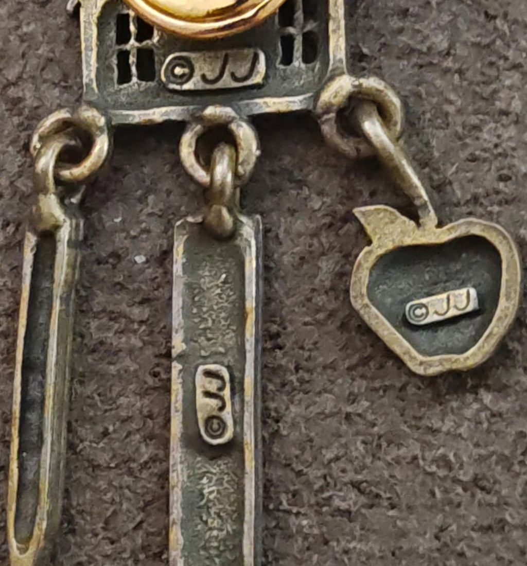 Close-up: JJ logo schoolhouse teacher charm dangle pin with heart and ruler