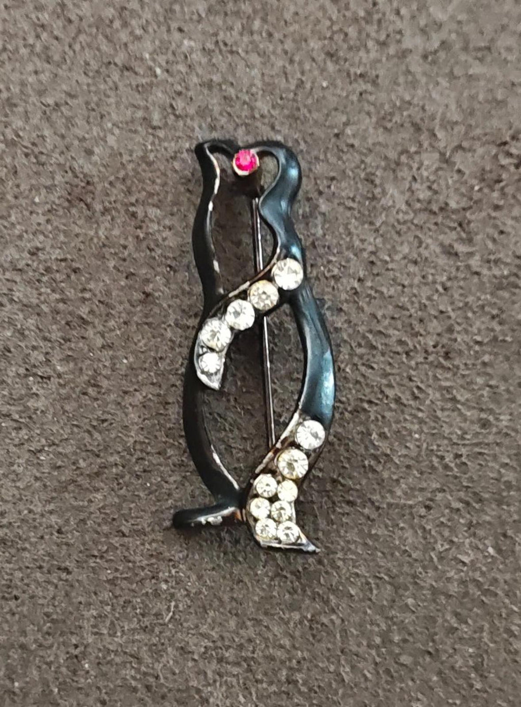 Black enamel penguin brooch with clear rhinestone accents and red heart center stone