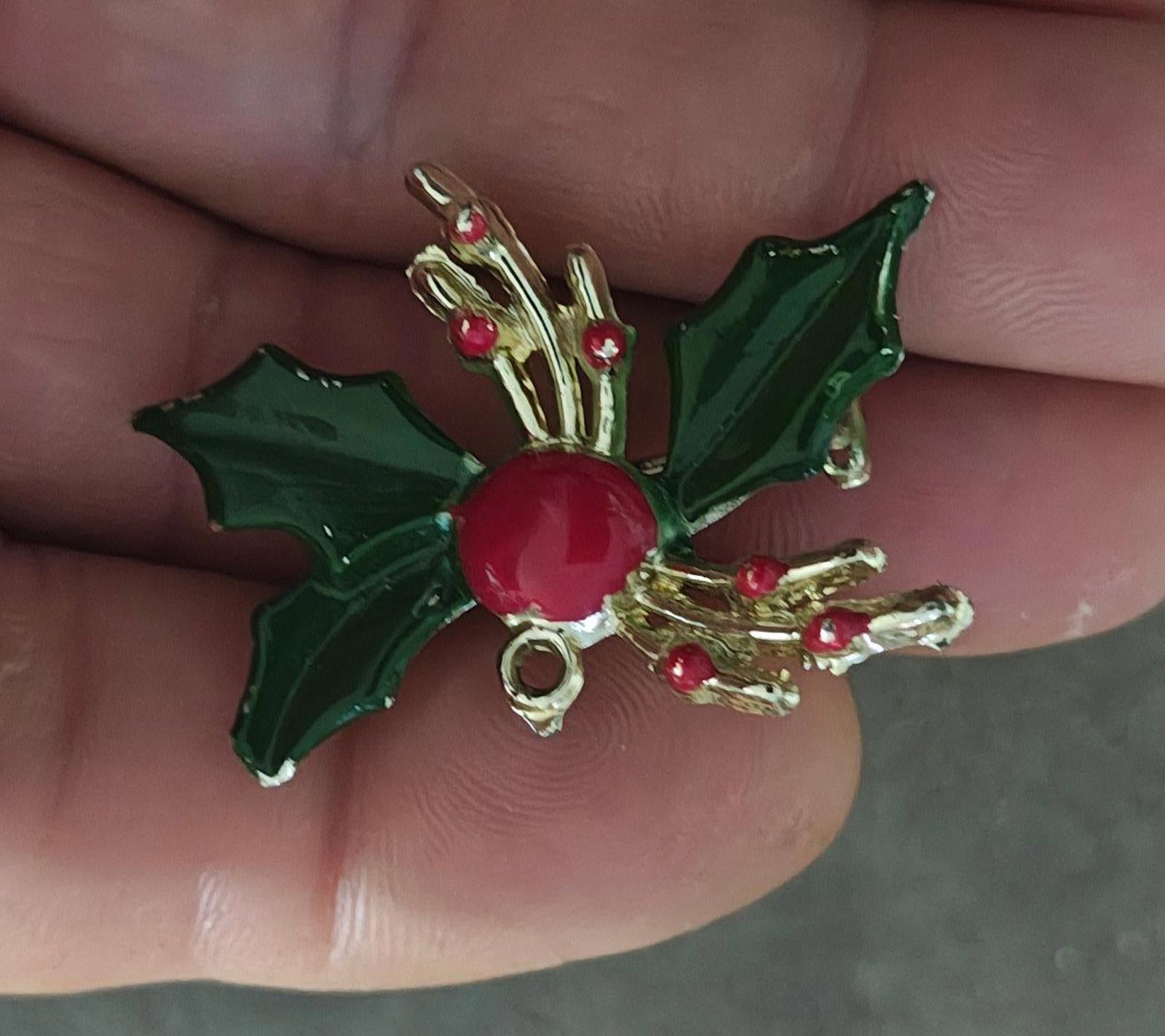 Holly enamel brooch pin with green leaves, red berry center, and gold-tone frame and arms