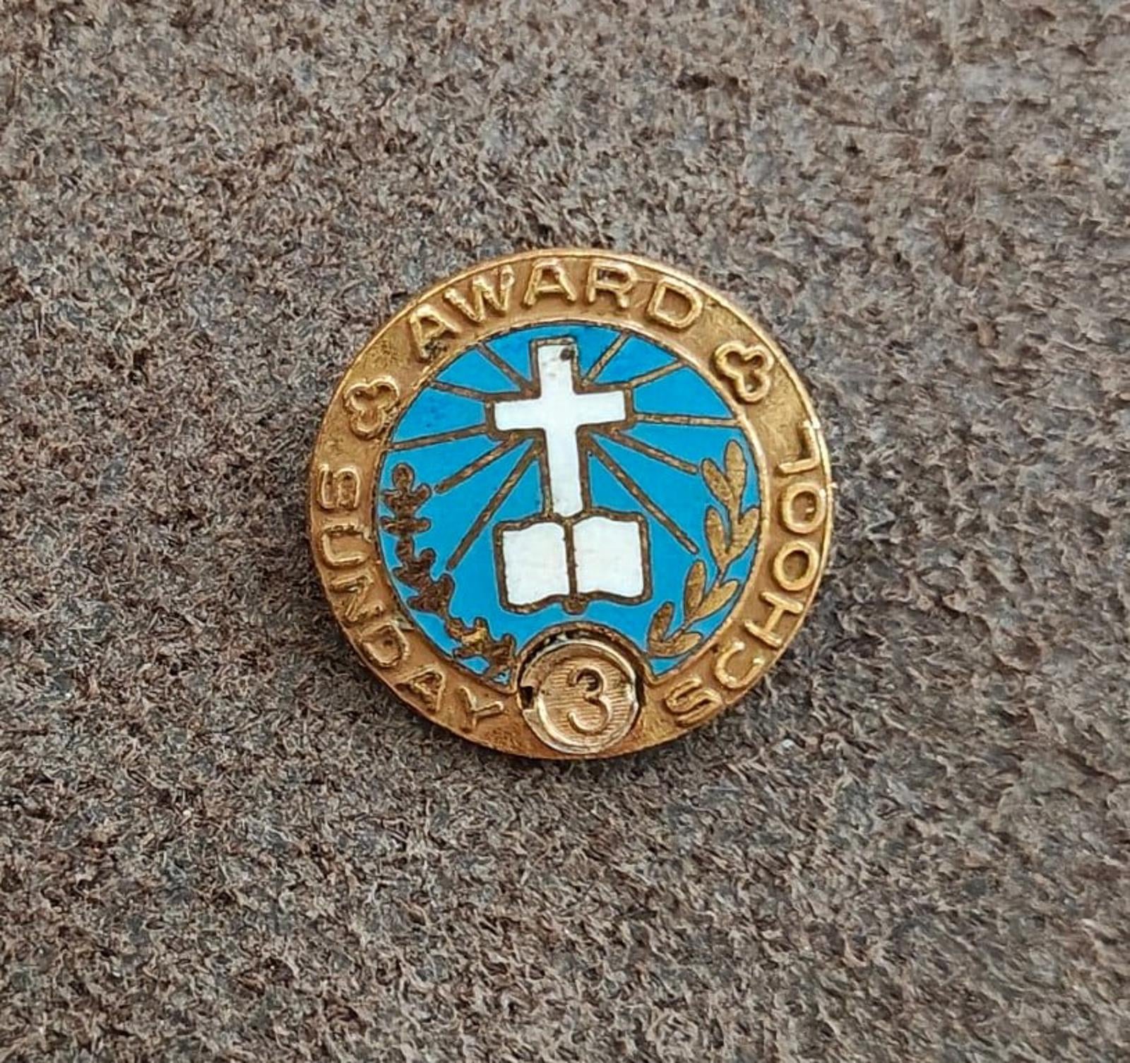 Vintage gold-tone award pin with blue enamel cross, laurel wreath, and "3" emblem