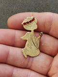 Gold-tone kneeling praying angel brooch with red rhinestone halo and raised hands