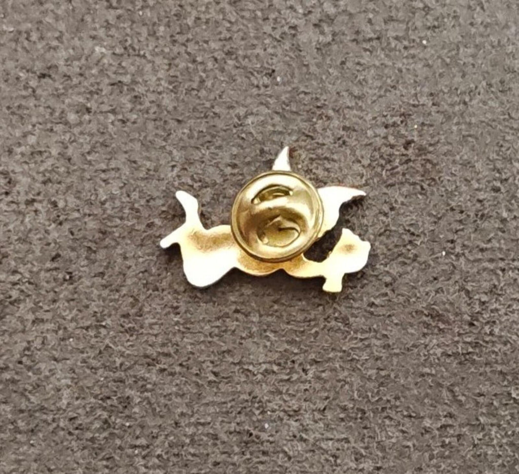 Gold tone angel brooch with spiral clasp, back view on fabric