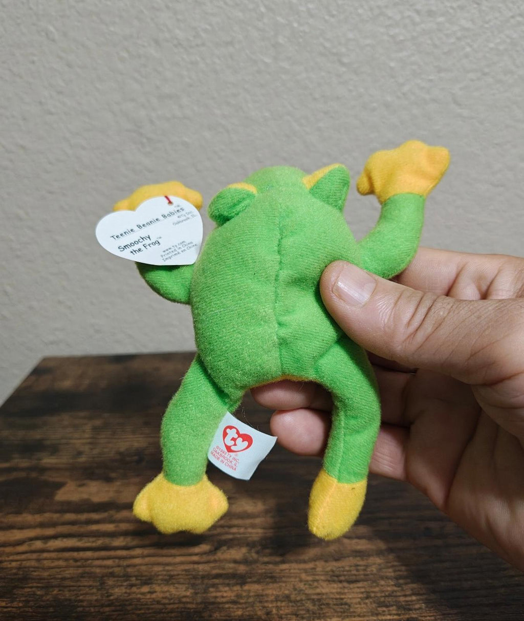Green frog beanbag plush backside view with white swing tag and red heart tag