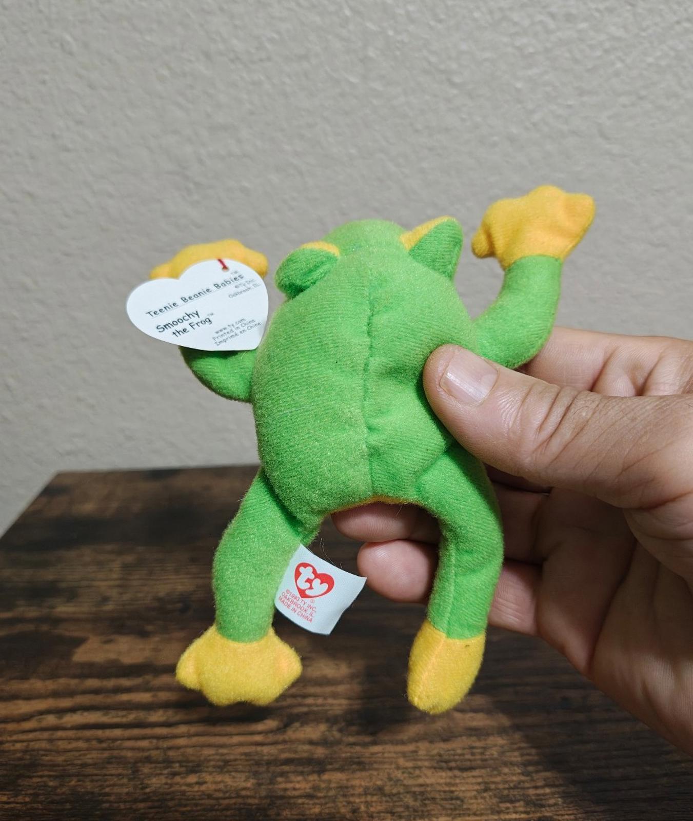 Green frog beanbag plush backside view with white swing tag and red heart tag