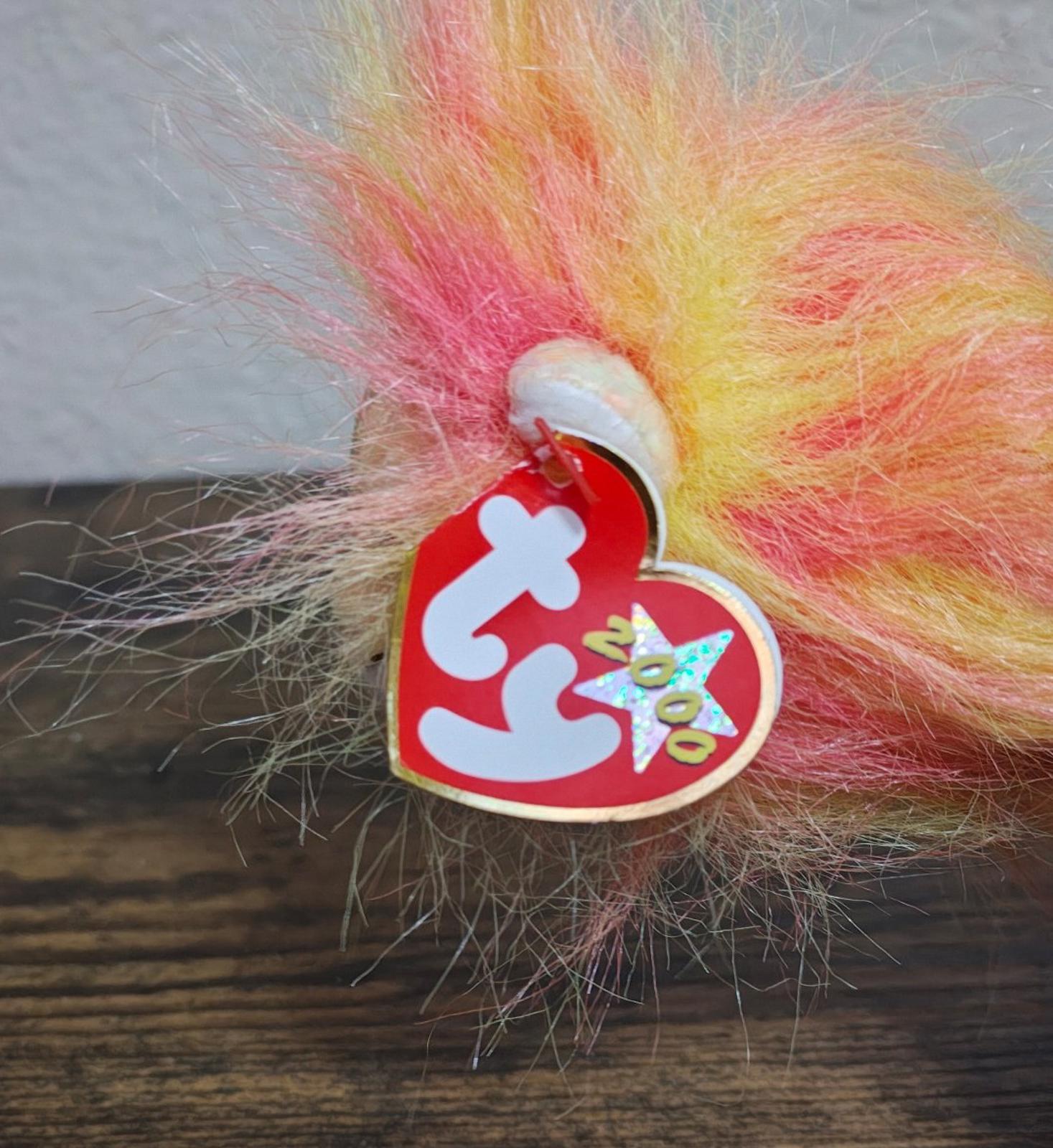 Close-up of red TY heart tag hanging on rainbow-furred lion plush