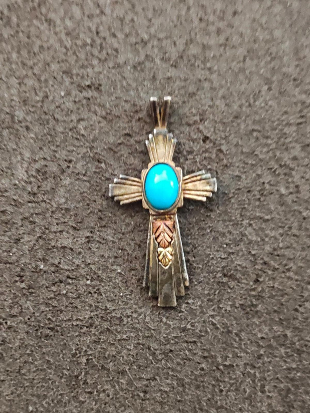 Turquoise inlay cross pendant with ornate shoulder cutouts and pointed top bail.