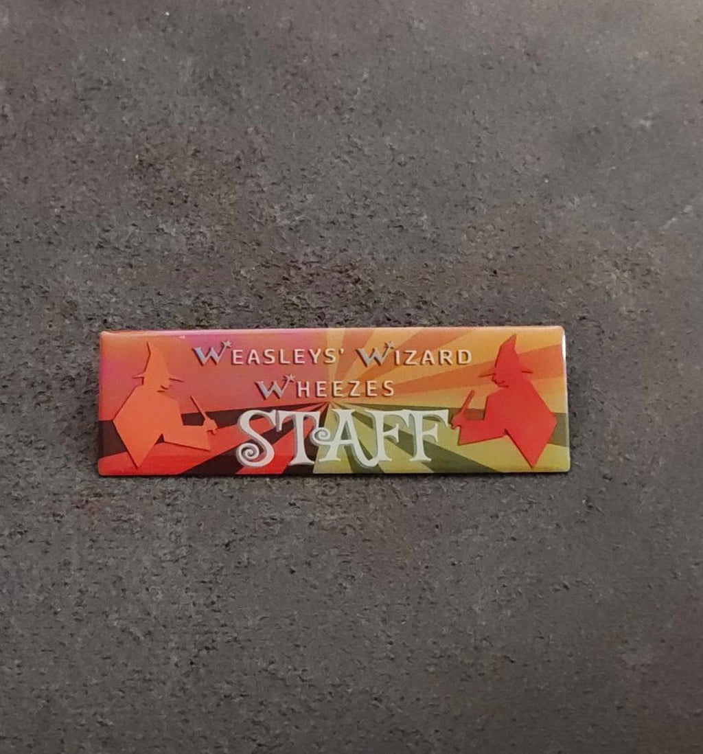 Orange rectangular “STAFF” wizard badge pin with “Weasleys’ Wizard Wheezes” text
