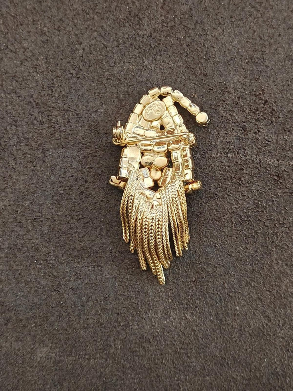 Gold-tone Santa brooch back with ridged metal details and multiple hanging chain strands