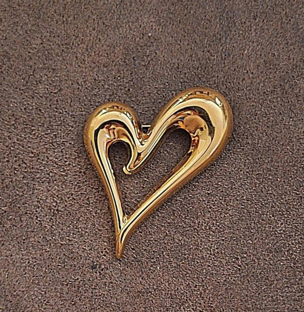 Gold heart-shaped pin with open center and high-relief curved border
