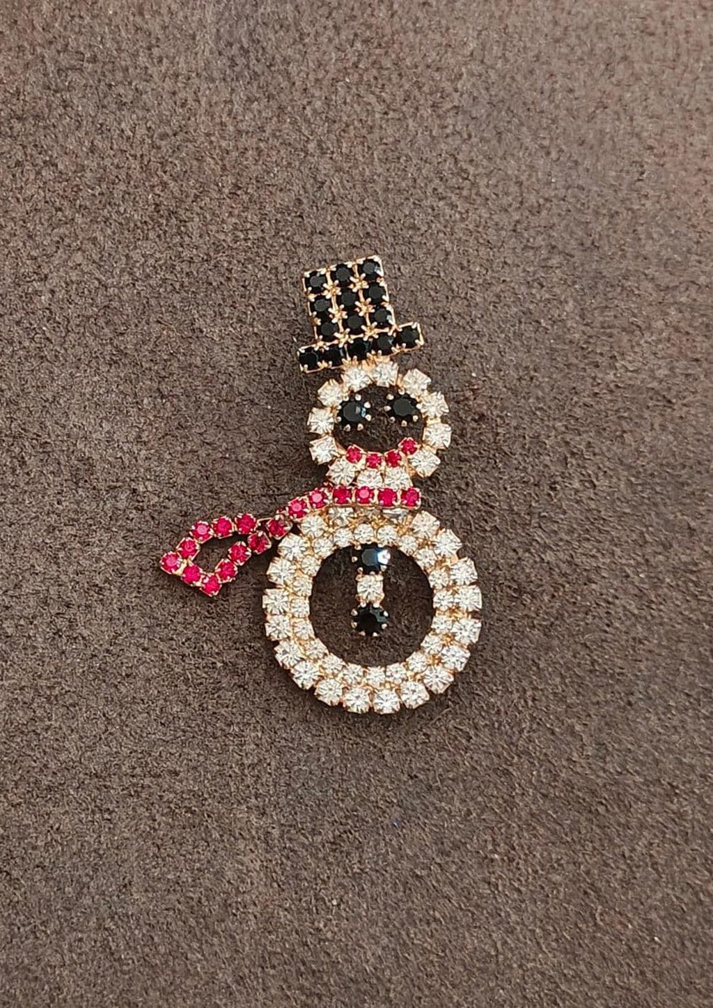 Gold-tone rhinestone snowman brooch on fabric with black head, red scarf and clear stones