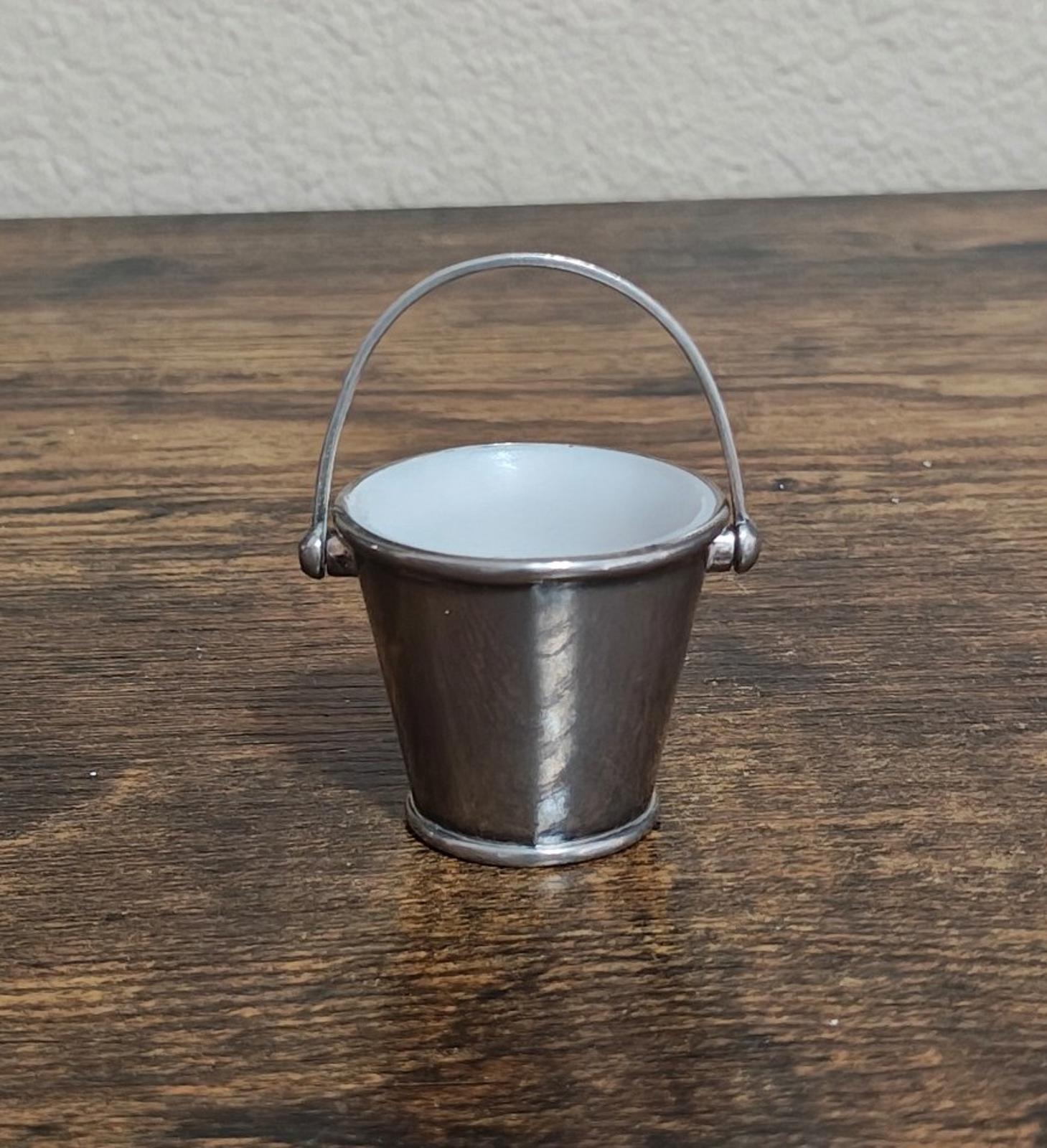 Mini silverplated bucket pail with tall arched handle and white interior