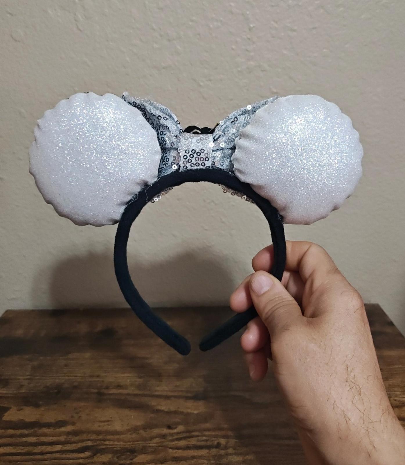 Silver glitter bow headband with black center and fabric bunny-style ears