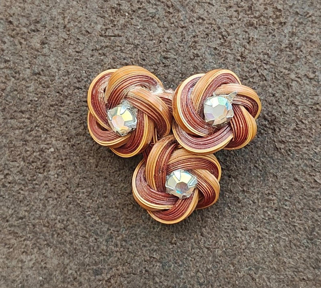 Three-flower bamboo rosette brooch pin with three iridescent rhinestones on brown and gold coils