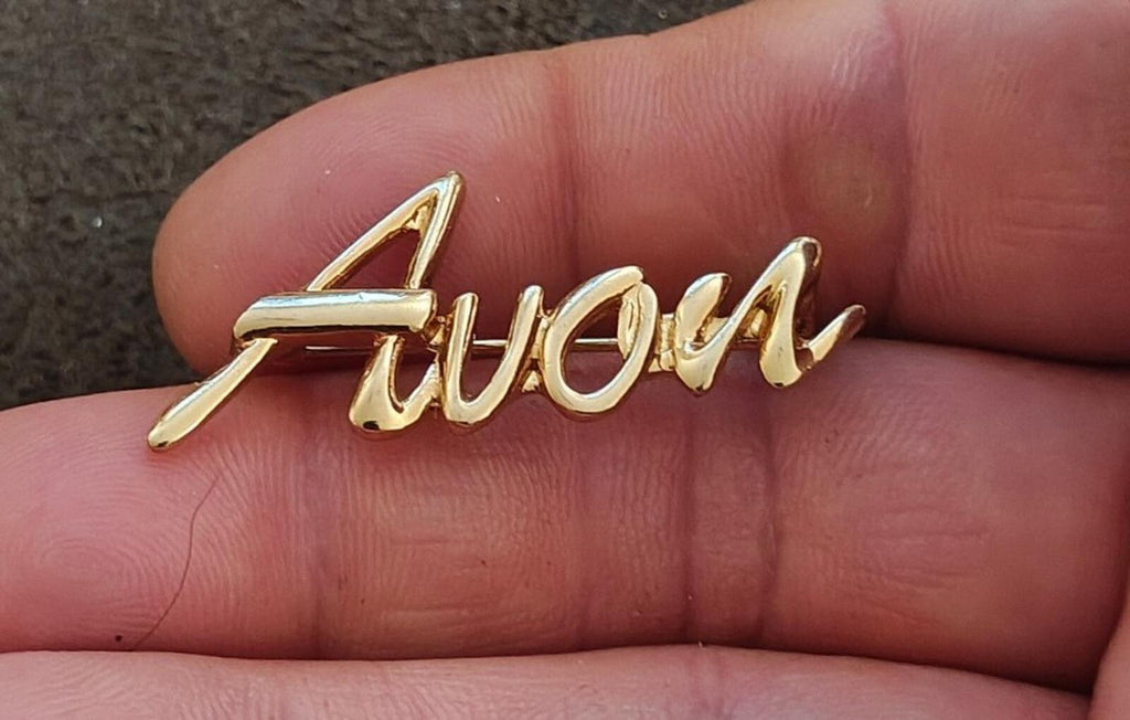 1980s/90s  Avon Gold Tone Cursive Logo Pin