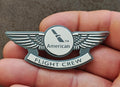 American Flight Crew badge pin with silver wings and circular American logo