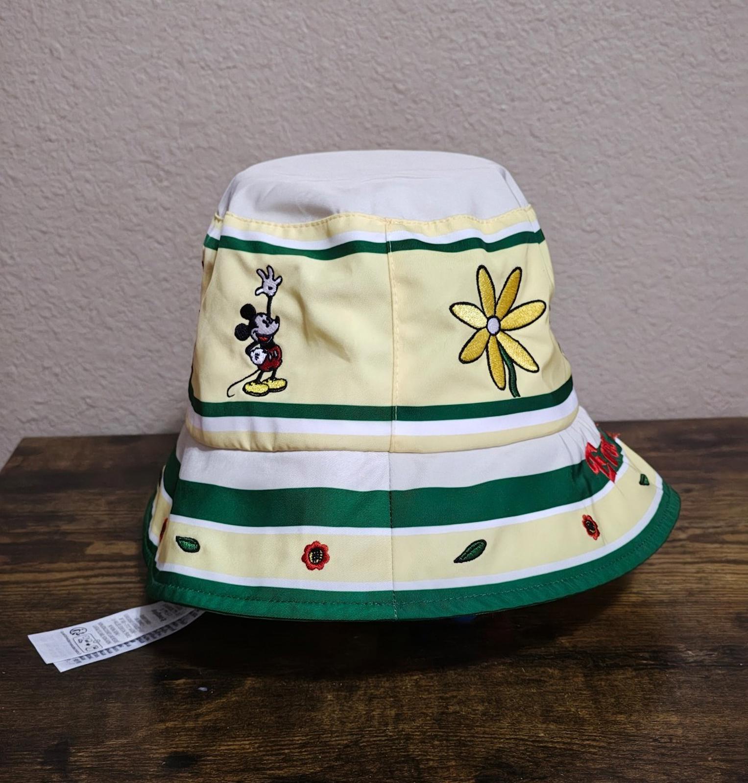 Cream bucket hat with green stripes, Mickey Mouse patch, “Ever After” text, red rose details