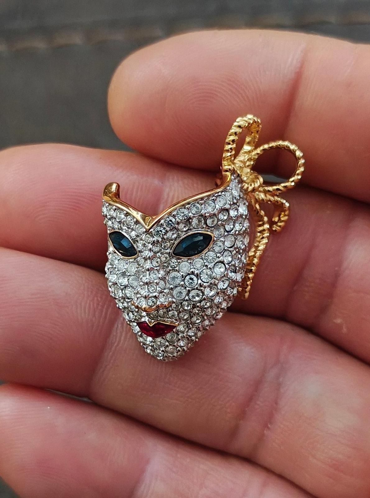 Swarovski Mardi Gras mask brooch with pave crystals and gold bow