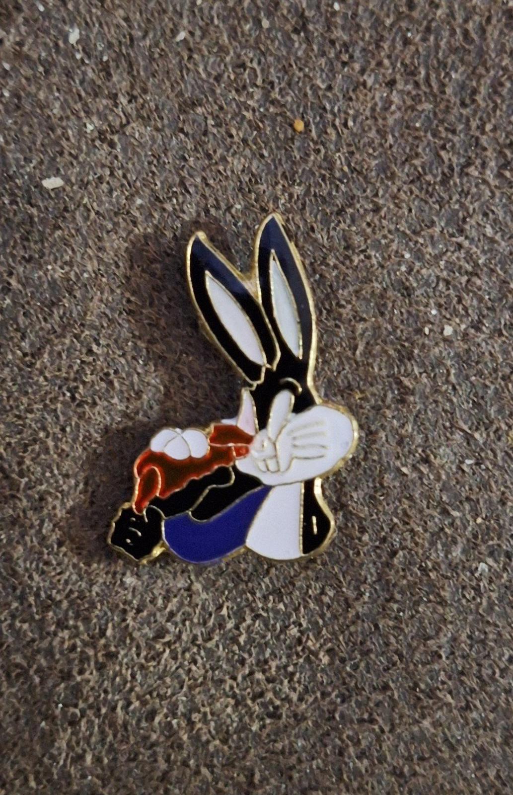 Enamel pin of Bugs Bunny holding carrot, colorful enamel character with gold outline