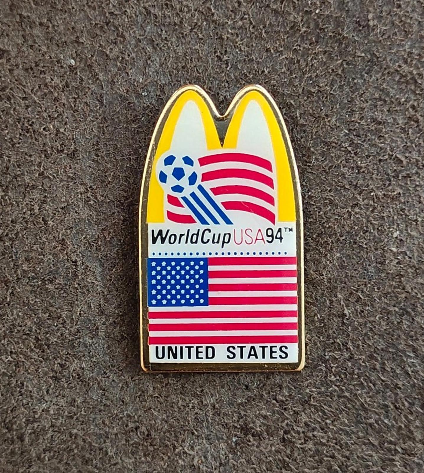 Gold-tone lapel pin showing soccer globe, WorldCup USA '94 text, and UNITED STATES