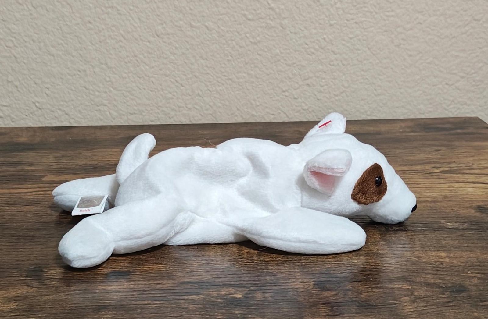 White plush dog lying flat with red Ty heart tag and small swing tag