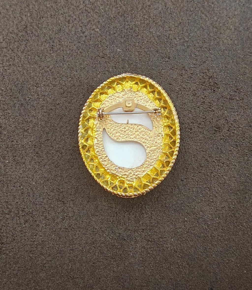 Gold-tone oval brooch pin back with safety clasp and gold textured frame