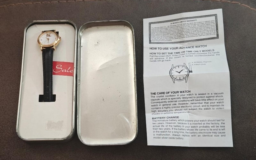 Ladies vintage watch in open box with instruction sheet and black leather strap