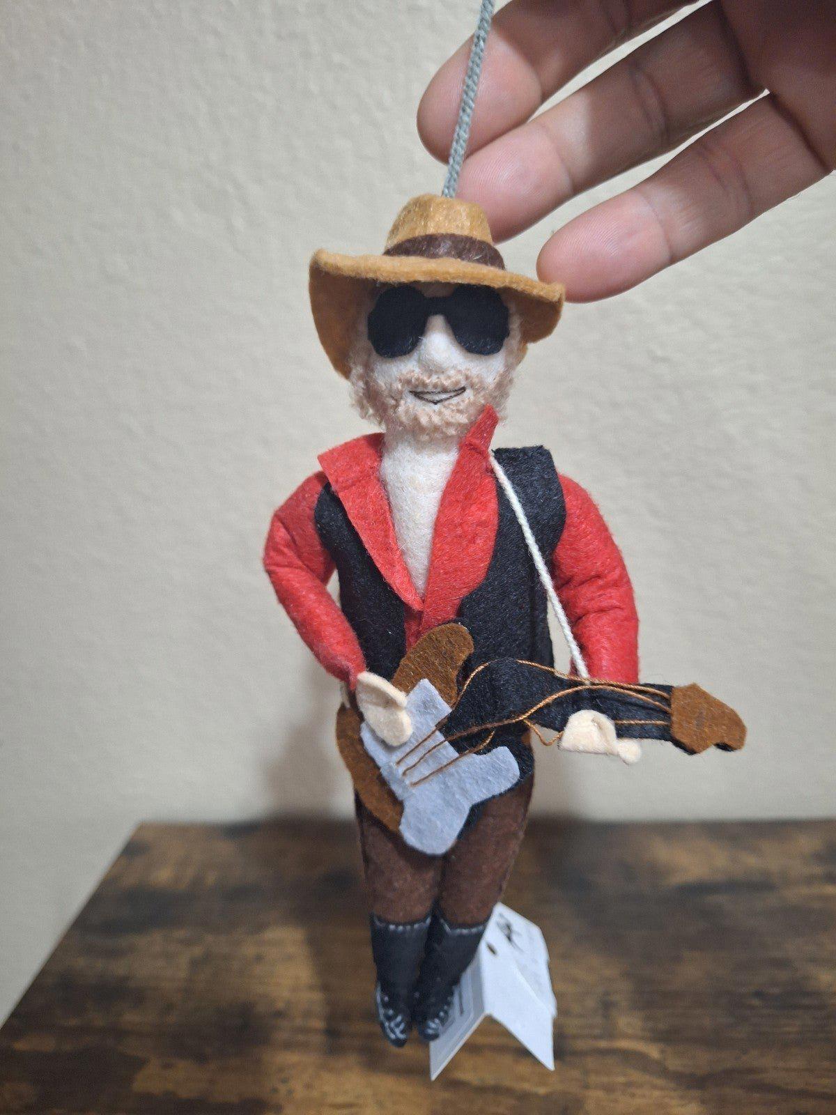 Felt and wool musician ornament with red jacket, black vest, hat, and guitar