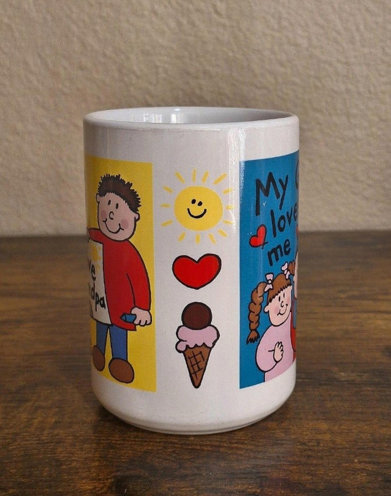 White ceramic mug with side panel graphics: heart, ice cream, sun, and cartoon characters