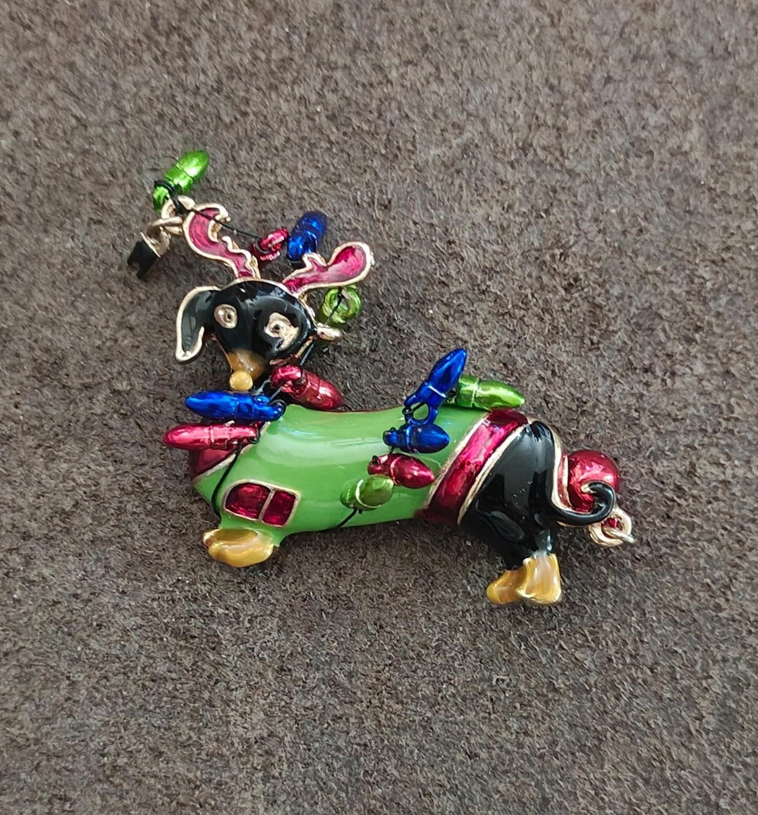 Dachshund dog enamel brooch side view, green body with multicolor antlers and red accents