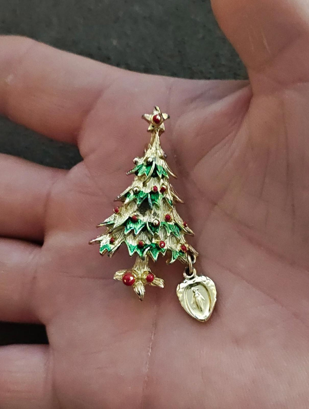 Small green enamel Christmas tree brooch with red berries and dangling heart medal charm