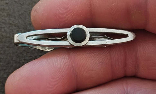 Silver open oval tie clip with circular black onyx stone center
