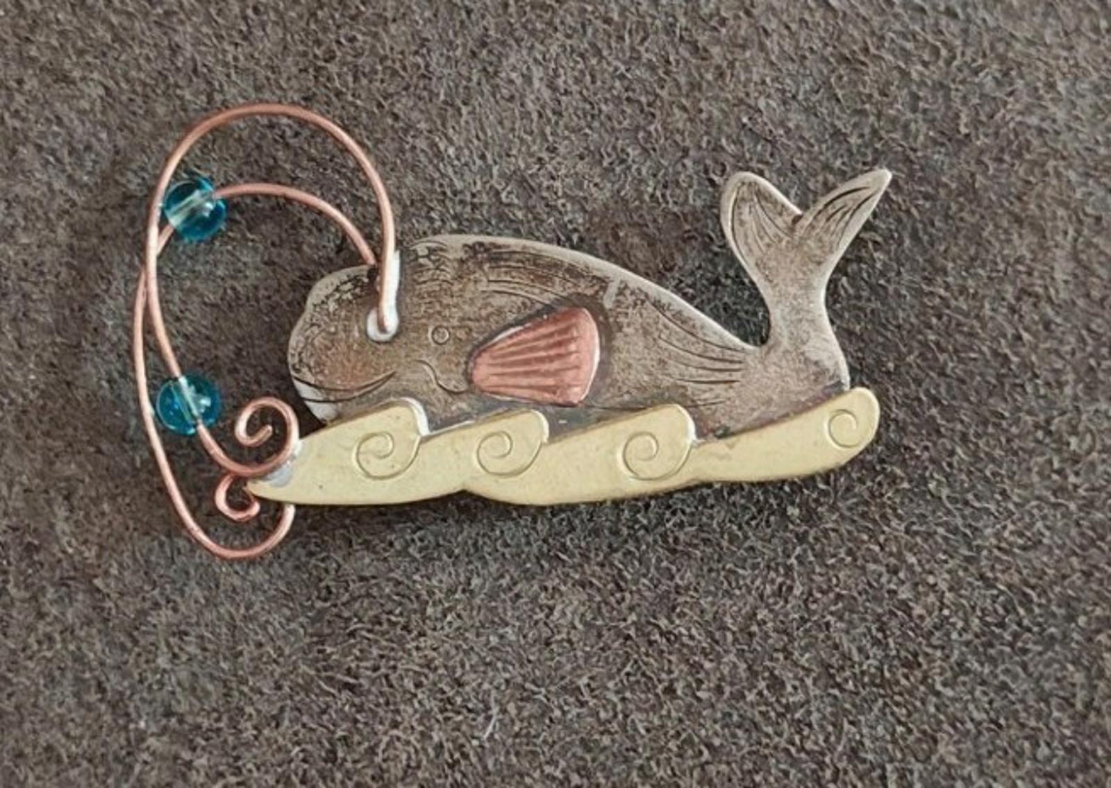 Gold-tone whale brooch pin with blue stones and orange fin, copper wire swirl and scrolls