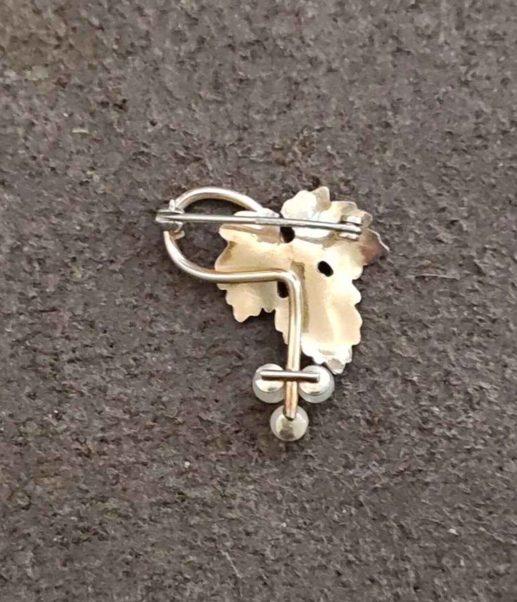 Back view of gold grape-vine brooch showing pin clasp and cultured pearl drops