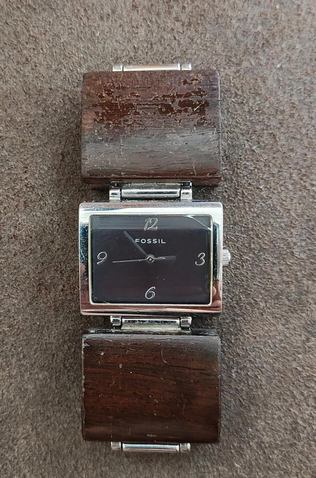 Ladies Fossil rectangular watch with dark dial, silver-tone case, brown wooden band