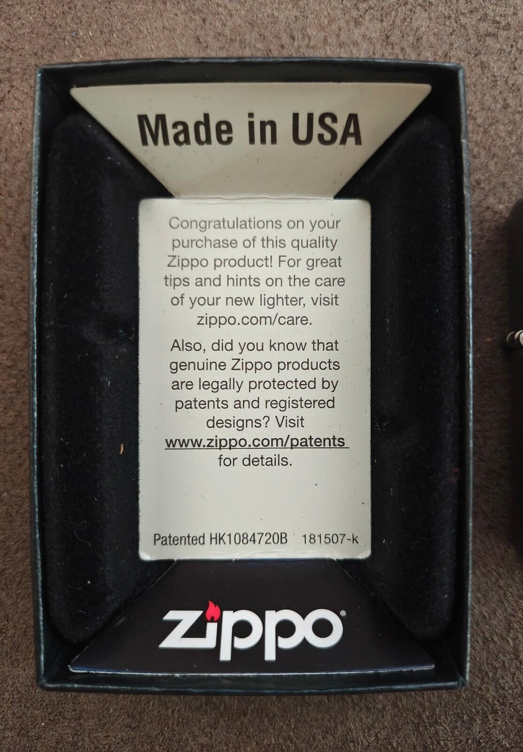 Silver Zippo windproof lighter in black box with “Made in USA” and warranty insert.