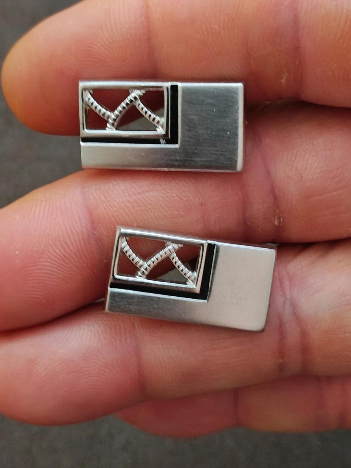 Silver-tone cufflinks front view with dark enamel center and crisscross design