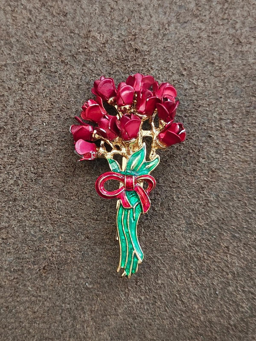 Red rose bouquet enamel brooch with gold-tone metal, green enamel stem, and ribbon bow