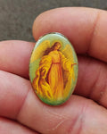 Oval lucite-style angel pin with gold-tone border and colorful guardian angel figure
