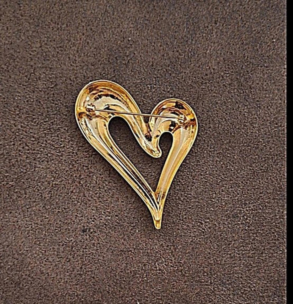 Gold heart-shaped pin with open center, smooth glossy finish and curved outline
