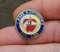 Gold-tone enamel teacher pin with blue border, “Make a Difference for Kids” text, apple icon.