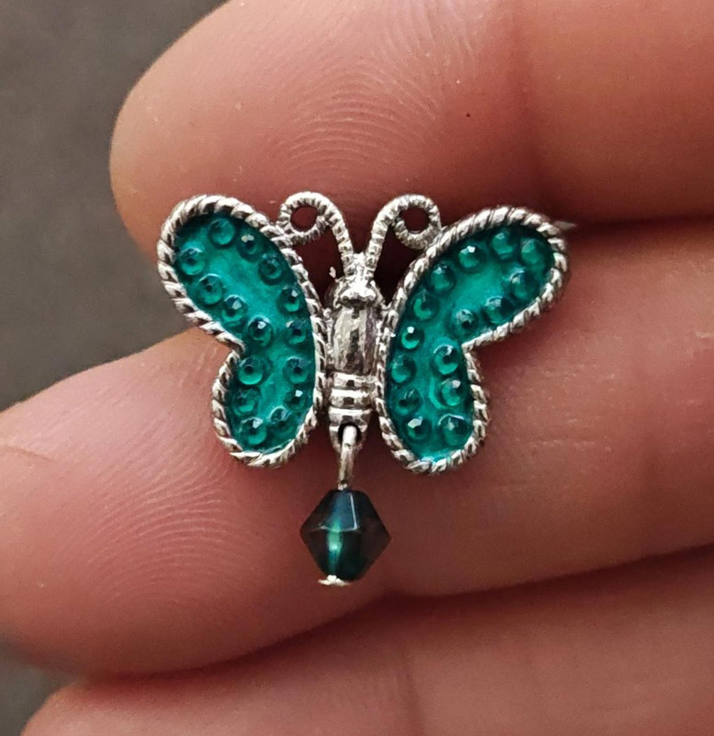 Silver-tone butterfly dangle pin with teal enamel wings and hanging teardrop charm