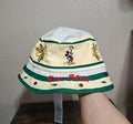 Cream bucket hat with green stripes, Mickey Mouse patch, “Ever After” graphic, flower accents